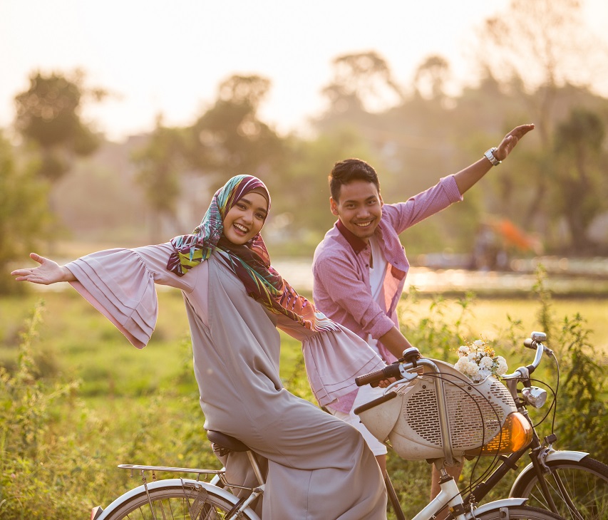 muslim couple enjoying ride a bicycle